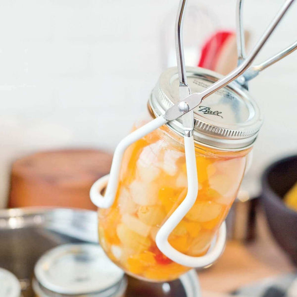 951-05645 CANNING JAR LIFTER - Canning Equipment. Lifting a hot jar from pan